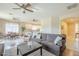 Spacious living room featuring neutral tones, ceiling fans, and an open floor plan to the kitchen and dining area at 4243 S Hackberry Trl, Gold Canyon, AZ 85118