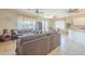 Open-concept living room featuring tile and laminate flooring, multiple ceiling fans, and lots of windows at 4243 S Hackberry Trl, Gold Canyon, AZ 85118