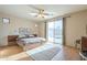 Spacious main bedroom featuring a ceiling fan, a sliding glass door and light hardwood floors at 4243 S Hackberry Trl, Gold Canyon, AZ 85118