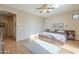 Bright main bedroom featuring a ceiling fan and light hardwood floors at 4243 S Hackberry Trl, Gold Canyon, AZ 85118