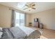 Bright main bedroom featuring a ceiling fan, a sliding glass door and light hardwood floors at 4243 S Hackberry Trl, Gold Canyon, AZ 85118