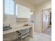 Functional office nook featuring built-in desk, storage cabinets, natural light, and tile flooring at 4243 S Hackberry Trl, Gold Canyon, AZ 85118