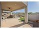 Covered outdoor patio area with outdoor kitchen, grill, and seating with a view of the desert landscape at 4243 S Hackberry Trl, Gold Canyon, AZ 85118