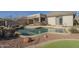 Inviting backyard pool area with a built-in bar, rock accents, and desert landscaping at 4243 S Hackberry Trl, Gold Canyon, AZ 85118