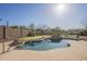 A refreshing in-ground pool is complemented by lush landscaping and a putting green at 4243 S Hackberry Trl, Gold Canyon, AZ 85118
