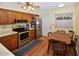 Inviting kitchen with stainless steel appliances, wood cabinets, and laminate flooring at 4328 E Capri Ave # 171, Mesa, AZ 85206