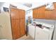 Laundry room with a washer, dryer, large cabinets, and water heater at 4328 E Capri Ave # 171, Mesa, AZ 85206