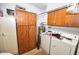 Laundry room with a washer, dryer, large cabinets, and water heater at 4328 E Capri Ave # 171, Mesa, AZ 85206