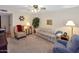 Cozy living room featuring neutral carpet, comfortable seating, and warm, inviting light fixtures at 4328 E Capri Ave # 171, Mesa, AZ 85206