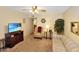 Comfortable living room featuring carpet flooring, neutral walls, and a media center at 4328 E Capri Ave # 171, Mesa, AZ 85206