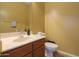 Cozy half bathroom featuring a pedestal sink, toilet, and neutral color scheme at 44115 W Palmen Dr, Maricopa, AZ 85138
