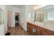 Primary bathroom with double sinks, shower, and walk-in closet at 44115 W Palmen Dr, Maricopa, AZ 85138