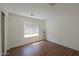Bright, airy bedroom with wood floors, a window and a closet offering natural light at 44115 W Palmen Dr, Maricopa, AZ 85138