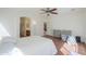 Bright bedroom featuring a ceiling fan, an ensuite bathroom and a nearby closet at 44115 W Palmen Dr, Maricopa, AZ 85138