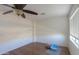 Bedroom with wood floors, ceiling fan, and a window with blinds allowing for natural light at 44115 W Palmen Dr, Maricopa, AZ 85138