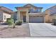 Charming home featuring a tile roof, a two-car garage, and a low-maintenance desert landscape at 44115 W Palmen Dr, Maricopa, AZ 85138