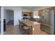 Charming kitchen with stainless appliances, plenty of counter space, and an island with bar seating at 44115 W Palmen Dr, Maricopa, AZ 85138