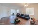 Spacious and well-lit living room with hard wood floors and neutral walls awaiting personalization at 44115 W Palmen Dr, Maricopa, AZ 85138