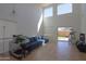 Open living room with tile floors, high ceilings, and natural light, perfect for relaxation and entertaining at 44115 W Palmen Dr, Maricopa, AZ 85138