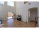 Bright living room featuring tile floors, high ceilings, and sliding doors to the backyard pool at 44115 W Palmen Dr, Maricopa, AZ 85138