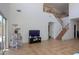 Open-concept living room showcasing high ceilings, staircase, and view of the backyard at 44115 W Palmen Dr, Maricopa, AZ 85138