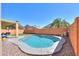 Sparkling private swimming pool in a backyard retreat with artificial grass and a covered patio at 44115 W Palmen Dr, Maricopa, AZ 85138