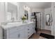 Bathroom featuring dual sinks, granite countertops, and updated fixtures at 44165 W Kramer Ln, Maricopa, AZ 85138