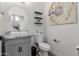 Powder bathroom features a modern sink, vanity with storage, and decorative artwork at 44165 W Kramer Ln, Maricopa, AZ 85138