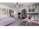 Bedroom featuring two beds, a ceiling fan, and large window at 44165 W Kramer Ln, Maricopa, AZ 85138