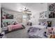 Bedroom featuring two twin beds, a ceiling fan, and bright decor at 44165 W Kramer Ln, Maricopa, AZ 85138