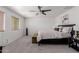 Spacious bedroom with neutral carpet, ceiling fan, and natural light at 44165 W Kramer Ln, Maricopa, AZ 85138