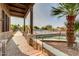 Community pool area with seating and a walking path, providing a relaxing outdoor space for residents at 44165 W Kramer Ln, Maricopa, AZ 85138