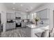 Bright kitchen featuring gray cabinetry, granite countertops, and modern stainless steel appliances at 44165 W Kramer Ln, Maricopa, AZ 85138