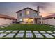 Expansive backyard featuring lush artificial turf, stylish stone pavers, and a covered patio for outdoor living at 4720 E Adobe Dr, Phoenix, AZ 85050