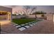 Private backyard oasis with artificial turf, decorative pavers, and a built-in seating area for relaxation and entertaining at 4720 E Adobe Dr, Phoenix, AZ 85050