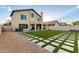 Well-maintained backyard featuring artificial turf, stone pavers, and a covered patio, ideal for outdoor enjoyment at 4720 E Adobe Dr, Phoenix, AZ 85050