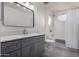 Bathroom featuring a gray vanity, modern fixtures, and a combined shower and bathtub at 4720 E Adobe Dr, Phoenix, AZ 85050
