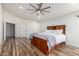 Bright bedroom featuring wood floors, a ceiling fan, and a built-in bed frame with storage drawers at 4720 E Adobe Dr, Phoenix, AZ 85050