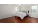 Bedroom showcasing a window and bed with wood floors at 4720 E Adobe Dr, Phoenix, AZ 85050