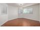 A bedroom featuring wood laminate flooring, white walls, and multiple windows, offering plenty of natural light at 4720 E Adobe Dr, Phoenix, AZ 85050