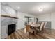 Elegant dining area with a modern fireplace, stylish seating, and sliding glass doors at 4720 E Adobe Dr, Phoenix, AZ 85050