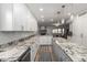 Well-lit kitchen boasting granite countertops, stainless steel appliances, and an open layout flowing into the dining area at 4720 E Adobe Dr, Phoenix, AZ 85050