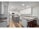 Bright kitchen featuring wood floors, an island with seating, white cabinets, and modern stainless steel appliances at 4720 E Adobe Dr, Phoenix, AZ 85050