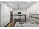 Spacious kitchen featuring stainless steel appliances, granite counters, white cabinets, and a center island at 4720 E Adobe Dr, Phoenix, AZ 85050