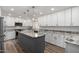 Modern kitchen with white cabinets, granite countertops, a large island, and stainless steel appliances at 4720 E Adobe Dr, Phoenix, AZ 85050