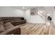 Spacious living area boasts wood flooring, a sectional sofa, and a view of the staircase at 4720 E Adobe Dr, Phoenix, AZ 85050