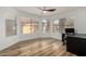 A well-lit living room includes wood laminate flooring, large windows, and a ceiling fan for comfortable living at 4720 E Adobe Dr, Phoenix, AZ 85050