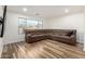 Cozy living room featuring a comfortable sectional sofa, wood floors, and a large window at 4720 E Adobe Dr, Phoenix, AZ 85050