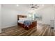 Bright and airy main bedroom with wood floors, ceiling fan, and natural light from the window at 4720 E Adobe Dr, Phoenix, AZ 85050