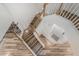 An overhead view showcases an open staircase with wood laminate steps and white banisters, connecting the home's floors at 4720 E Adobe Dr, Phoenix, AZ 85050